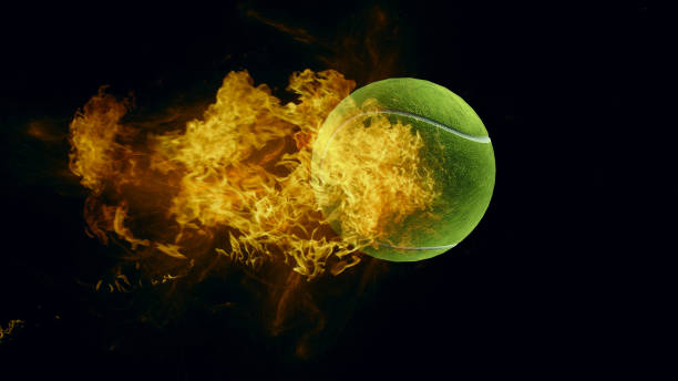 istock tennis ball in fire, isolated dark background. 3d render. 1235158214