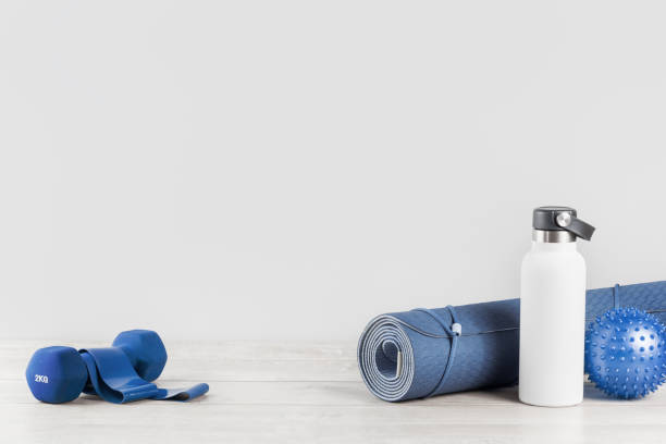 istock Rolled yoga mat and metal water bottle 1235158887