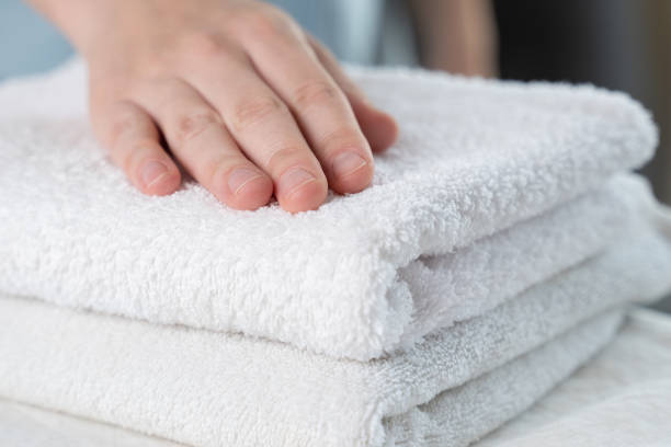 istock A woman touches a fresh white towel 1235159267
