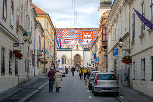 Zagreb / Croatia - December 2018 : People and visitor are walking on the main road straight to St. Mark's Church is the famous landmark of Croatia at Zagreb upper-town.