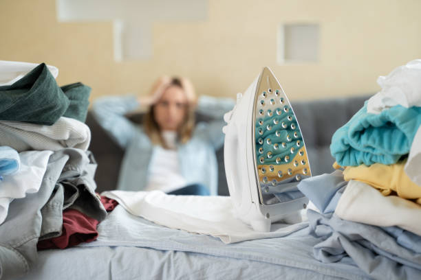 istock Young happy couple opening cardboard box after relocation and looking inside 1235173785