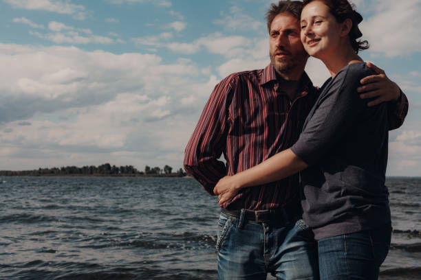 istock Loving couple with age difference rest on river bank 1235174835