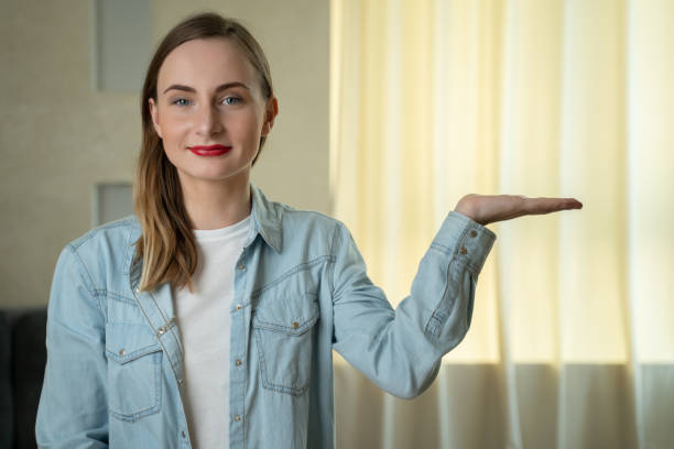 istock Young woman showing and presenting with open hand palm 1235180499