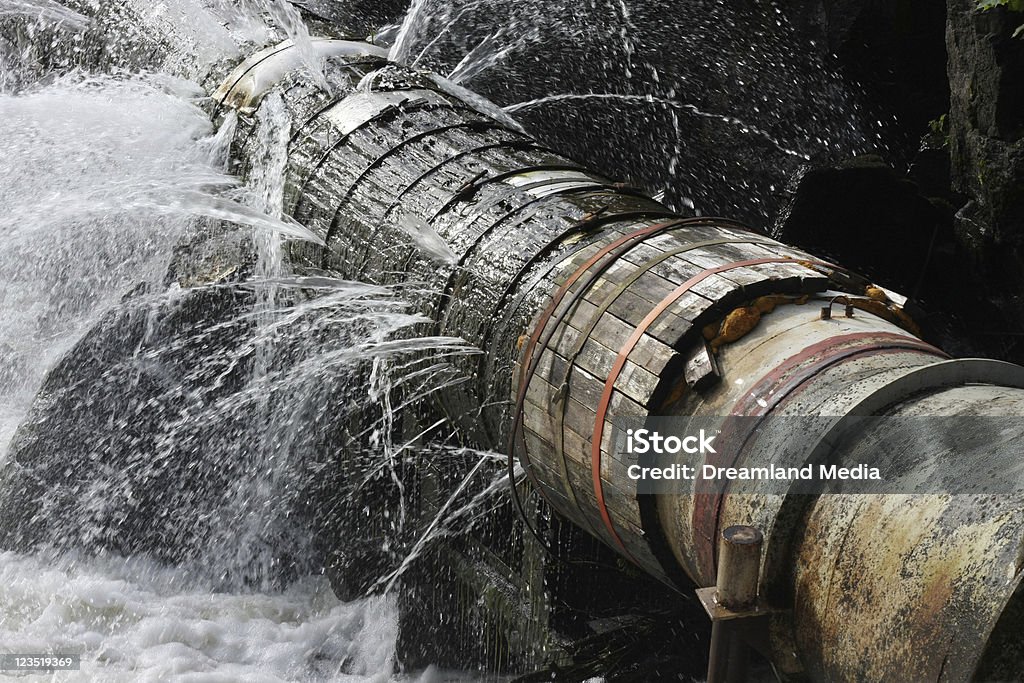 Old Leaking Pipe A broken pipe that leaks water in all directions. Water Pipe Stock Photo