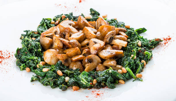 istock Fried mushrooms with cream of spinach. Vegetarian dish. On white background 1235201659