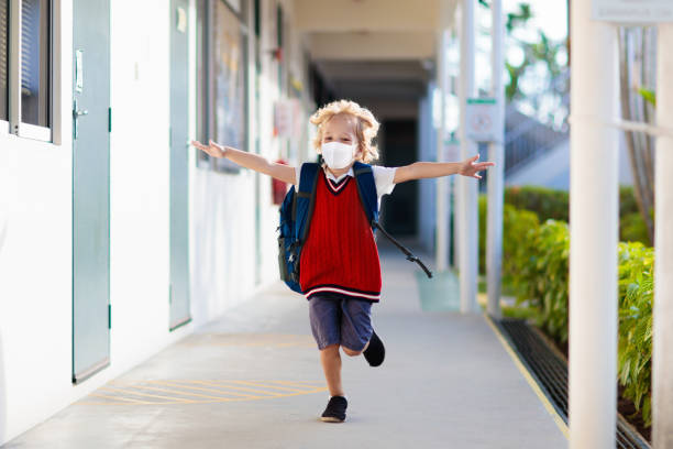 istock Child wearing face mask. Virus outbreak. 1235212596