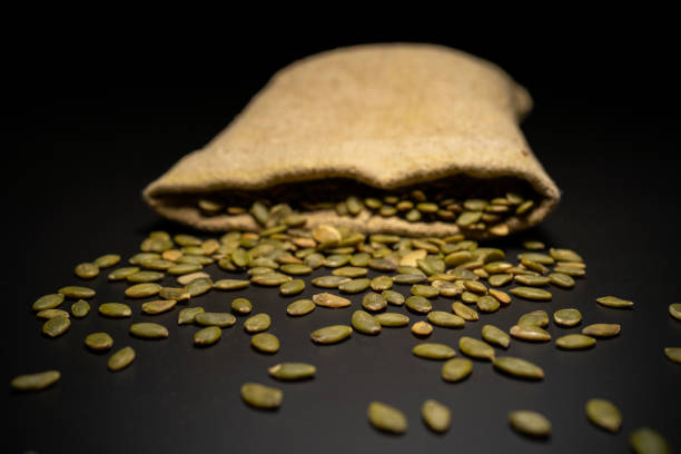 Dried pumpkin seeds from a sac on a table