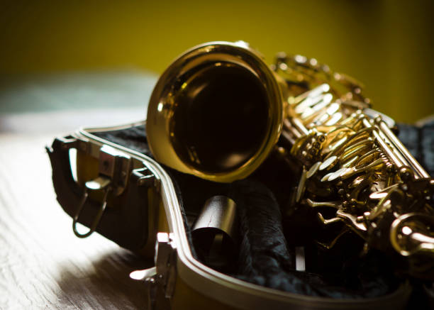 close up of alto saxophone in open case on table