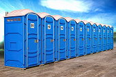 Portable plastic toilets in a row.