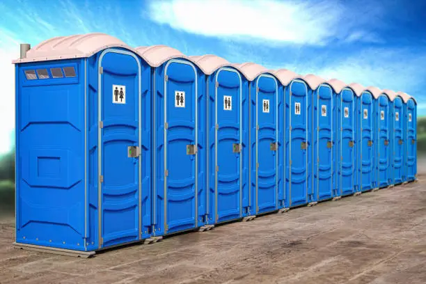 Photo of Portable plastic toilets in a row.