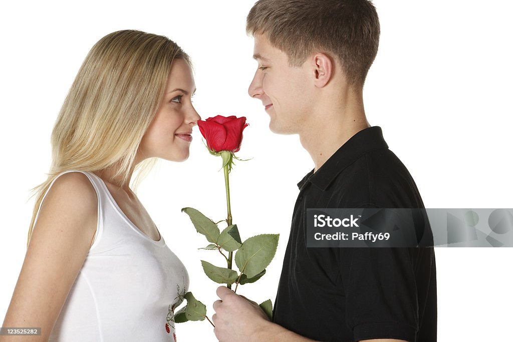 Young couple with rose Young couple with rose isolated on white Adult Stock Photo