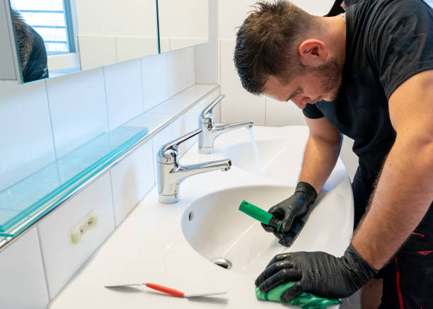 istock professional cleaner removing lime scale from a ceramic bathroom sink with a diamond blade scraper and cloth 1235283938