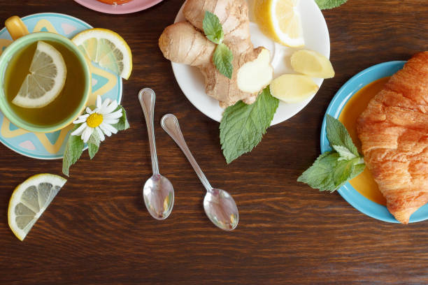 istock Cup with green tea and lemon on the wooden background 1235295340