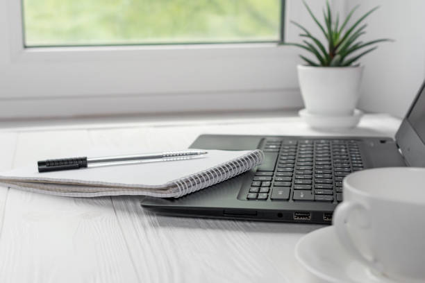 istock Workplace for distance learning at home with black laptop, pen and notebook 1235300123
