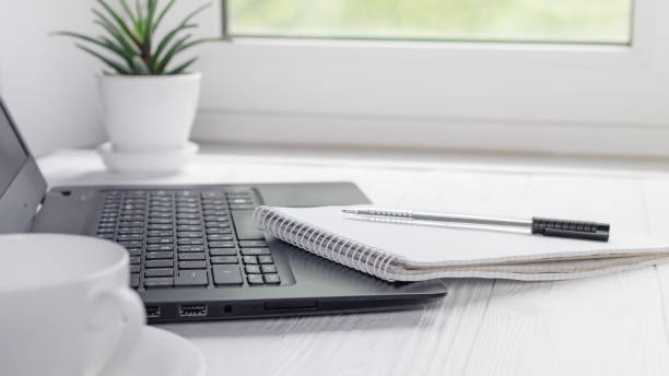 istock Workplace for distance learning at home with black laptop, pen and notebook 1235300640