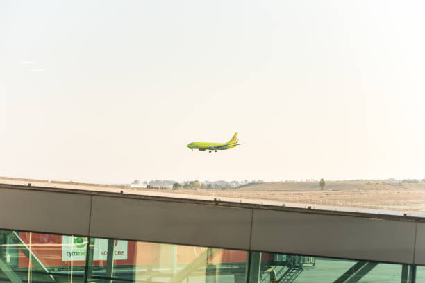 Aircraft of S7 airlines about to land at the airport of Larnaca (Larnaka) fort of Cyprus Aircraft of S7 airlines about to land at the airport of Larnaca (Larnaka) fort of Cyprus larnaca international airport stock pictures, royalty-free photos & images