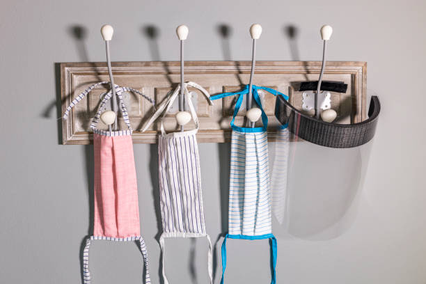 istock Coat rack with safety mask and protective screen 1235334406