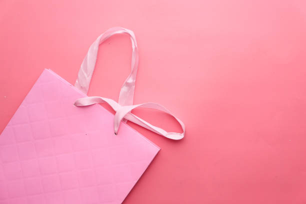 istock close up pastel shopping bag on pink background 1235367916