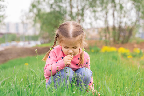 istock little girl sniffs the flowers 1235378550