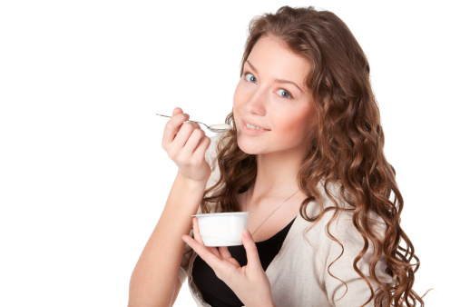 happy young fun woman eats sushi on black background