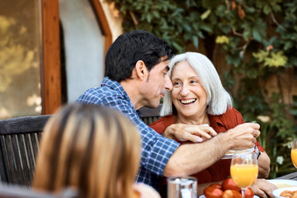 istock Smiling Senior Woman and her son Conversing at Breakfast. 1235400689