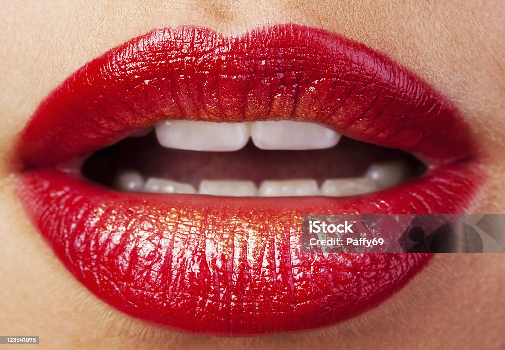 Beautiful lips Closeup of lips with red lipstick and gold Adult Stock Photo