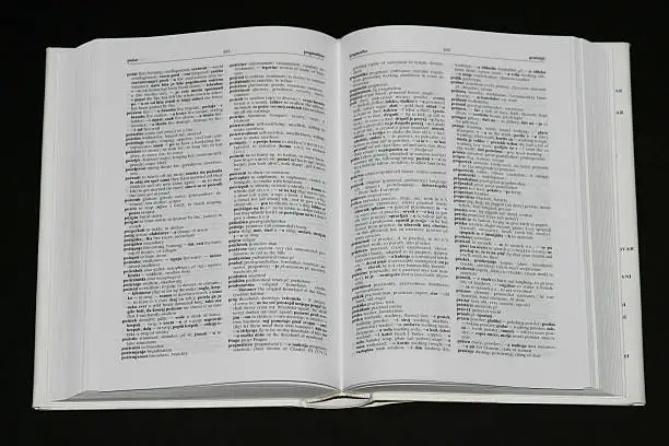 White dictionary on black background.