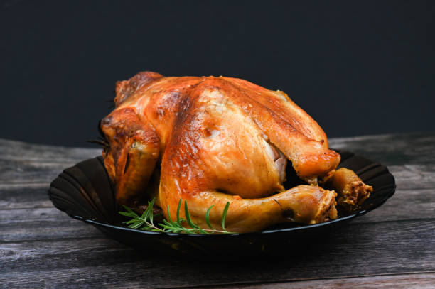 istock Baked turkey on wooden background 1235440417