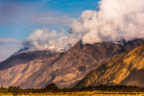 istock Large clouds covering the snowy peaks in Leh, India 1235442502