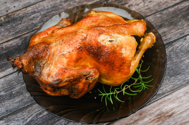 istock Baked turkey on wooden background 1235443025