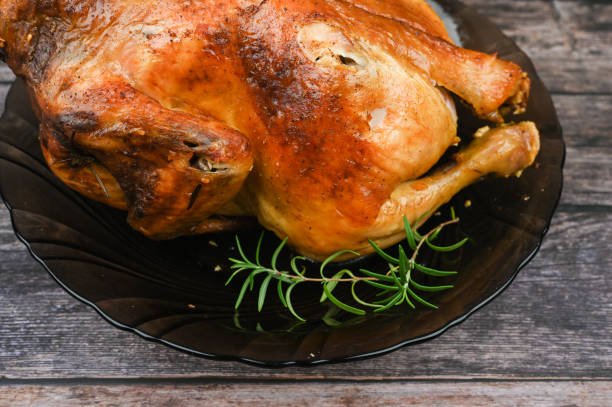 istock Baked chicken on wooden background 1235450359