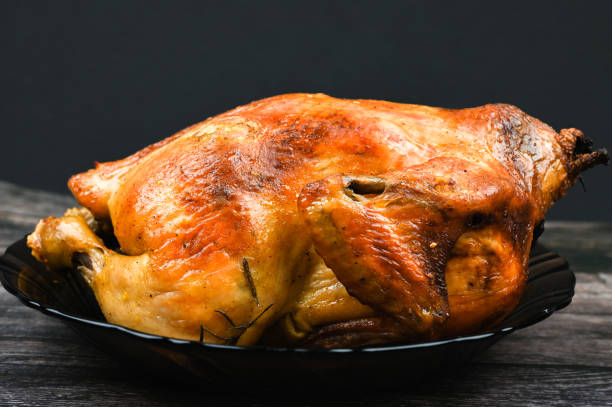 istock Baked turkey on wooden background 1235453217
