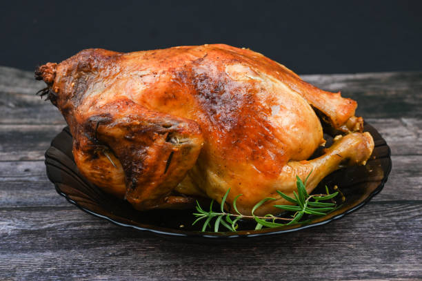 istock Baked chicken on wooden background 1235454578