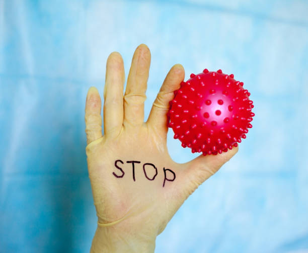 istock Stop Covid-19. Text on medical glove. 1235474487