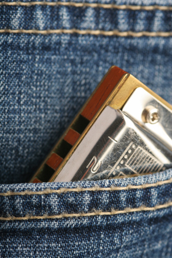 Jeans pocket with mouth harmonica.