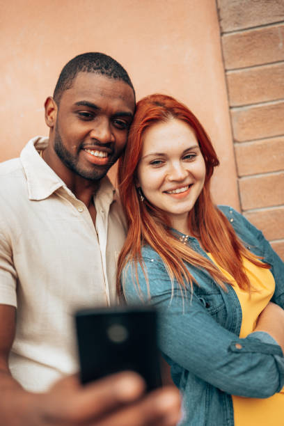 istock interracial couple take a selfie portrait together 1235552821