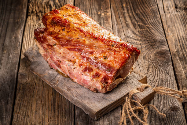 istock roasted pork on rustic wooden cutting board, top view banner menu recipe place for text 1235565322