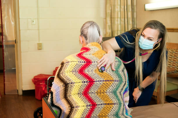 istock Nurse listening to a patient's lungs 1235567457
