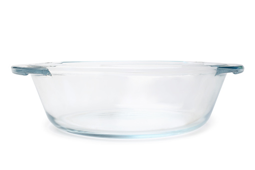 Empty glass casserole pan on white background