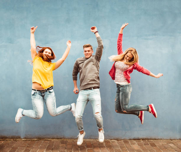 istock happiness friends jumping together 1235582734