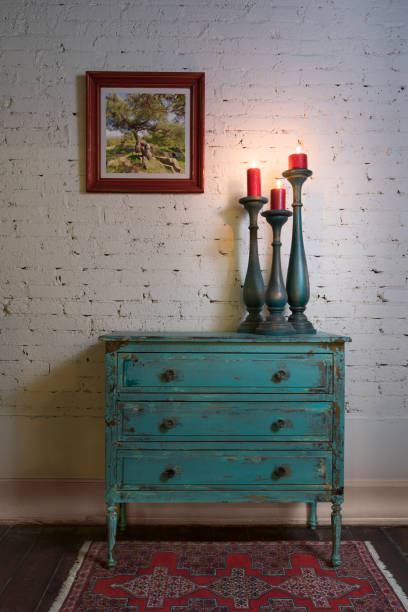 istock Green vintage cabinet, candlesticks and hanged painting on bricks wall 1235588973