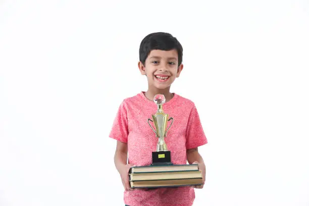 Boy with books and award, trophy