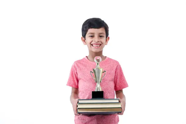 Boy with books and award, trophy