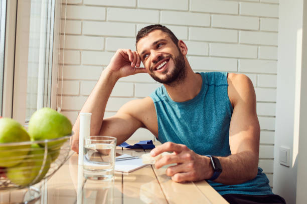 istock Cheerful young man sitting at the table at home 1235614167