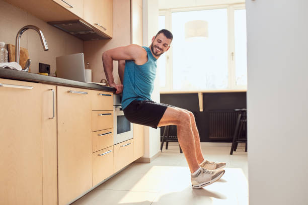 istock Cheerful young man working out in kitchen 1235614219