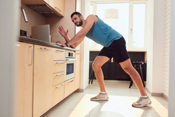 istock Handsome young man working out in kitchen at home 1235614282