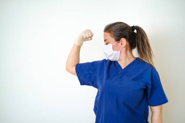 doctora que muestra brazo fuerte - human muscle women bicep girl power fotografías e imágenes de stock