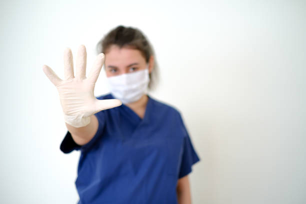 A Single White Fabric Glove Making an OK Gesture Against a White Background
