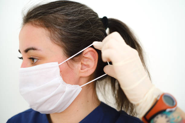 istock Female doctor with surgical mask on white background 1235636699