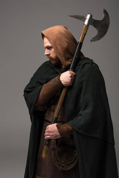 istock medieval Scottish redhead man in mantel with battle axe on grey background 1235640068
